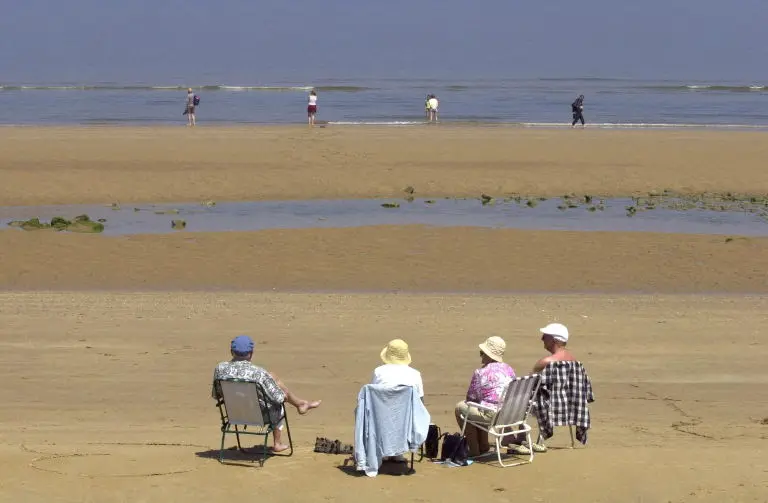 Aposentados curtem o litoral francês em St-Laurent-sur-Mer, um dos destinos mais procurados da Normandia
